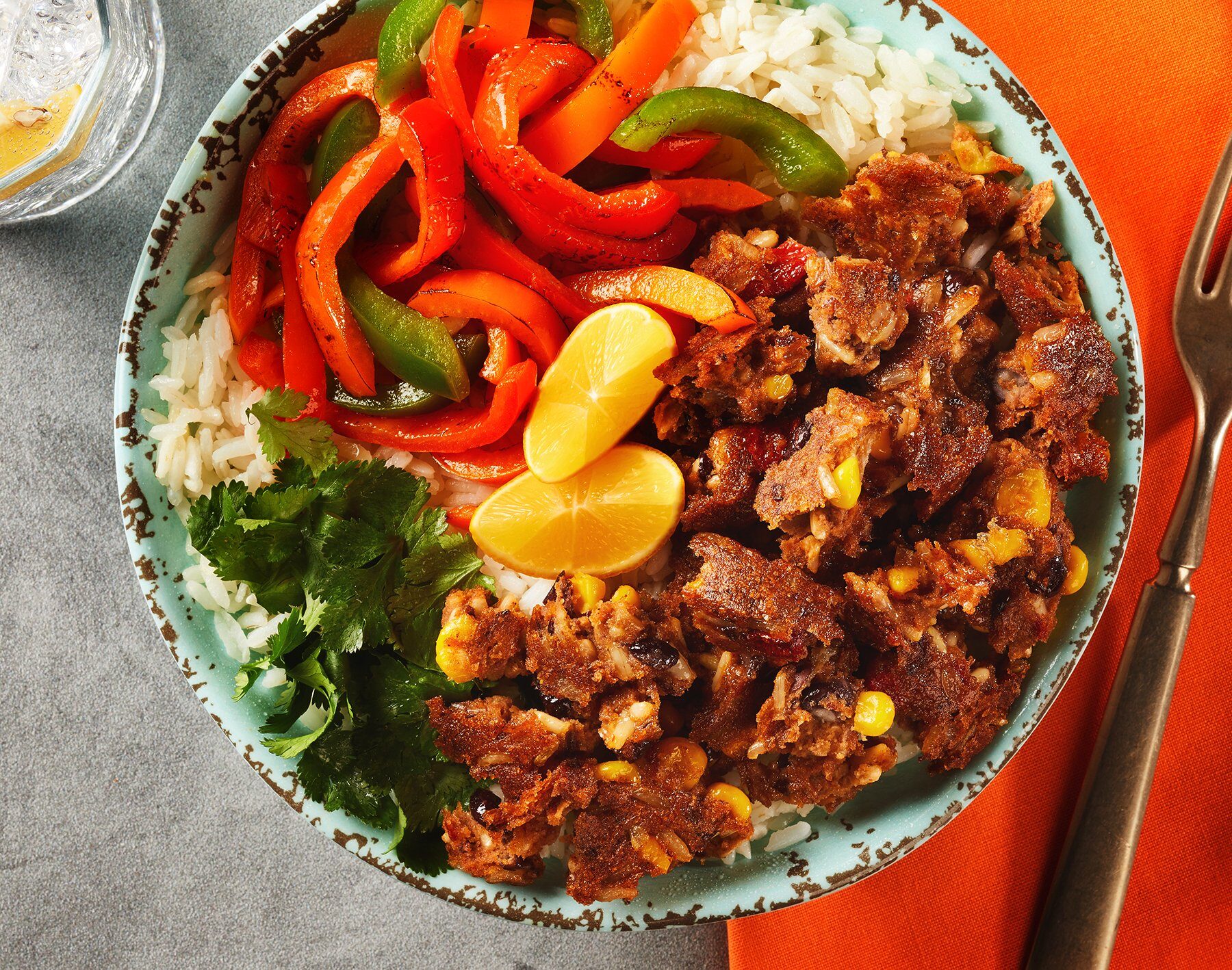 Southwest crumble burrito bowl with rice, peppers, corn and lime