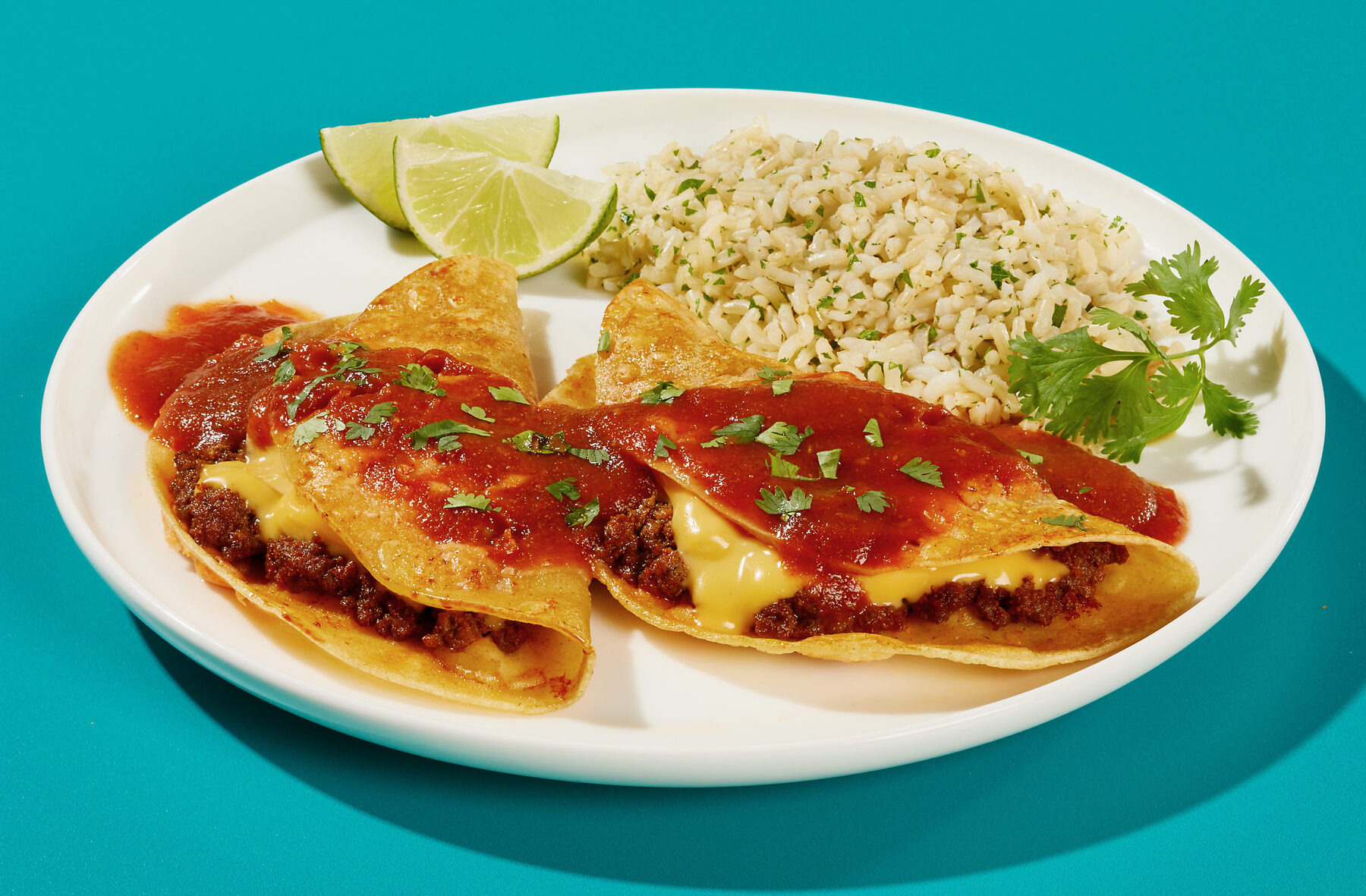 Taco enchiladas baked and sauced